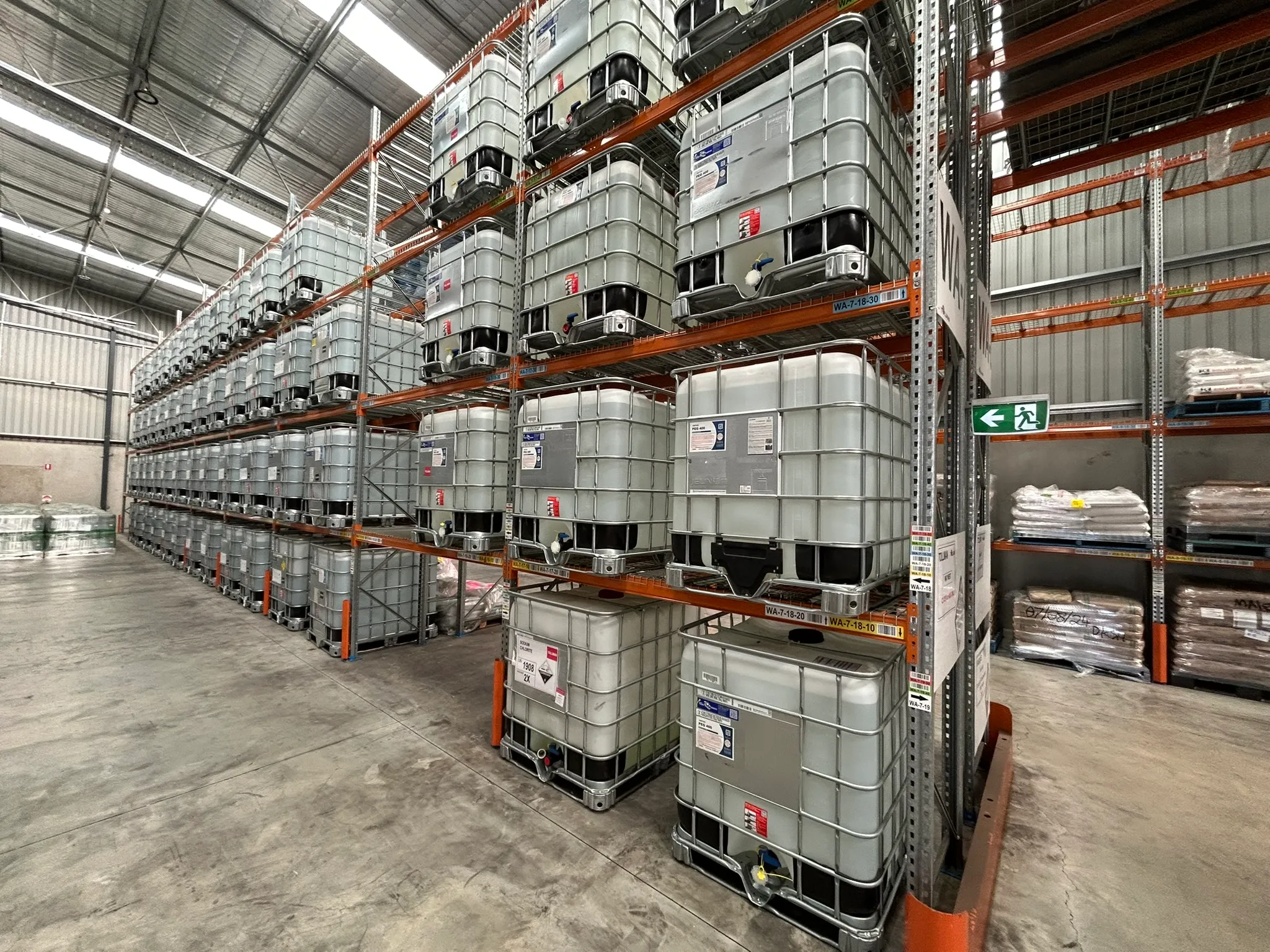 Tollman warehouse interior — racked IBC totes